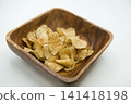Potato chips served in a wooden bowl Potato chips served in a wooden bowl 141418198