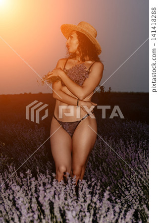 Woman lavender field straw hat posing in nature during golden hour sunset while holding fresh flowers for lifestyle summer photography Woman lavender field straw hat posing in nature during golden hour sunset while holding fresh flowers for lifestyle summer photography 141418288