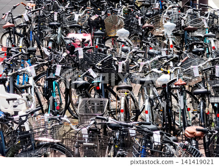 Abandoned bicycles are densely packed together in the city streets. Abandoned bicycles are densely packed together in the city streets. 141419021