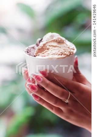 Elegant Female Hands Holding Artisan Gelato with Premium Lifestyle Aesthetic 141419646
