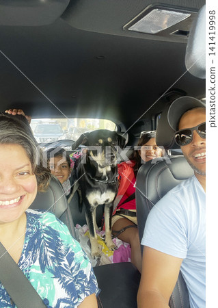 Family road trip with pet dog in car. UGC 141419998