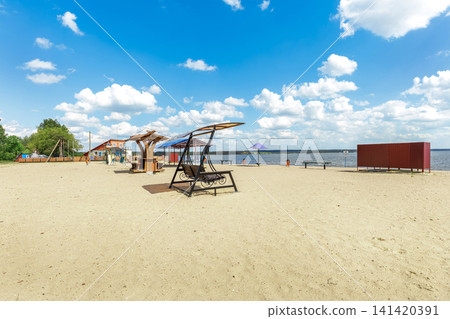 Public Beach with Swings and Lake View on a Sunny Day Public Beach with Swings and Lake View on a Sunny Day 141420391
