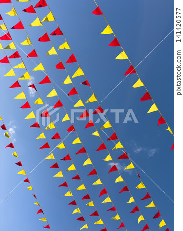 Red and yellow flags on blue sky backround 141420577
