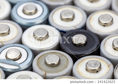 Detailed Macro Close-Up of Many Cylindrical AA and AAA Alkaline Batteries Packed Together Showing Positive Terminal Ends with Metal Nubs Mixed Colors Detailed Macro Close-Up of Many Cylindrical AA and AAA Alkaline Batteries Packed Together Showing Positive Terminal Ends with Metal Nubs Mixed Colors 141422025