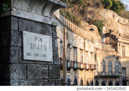 Naples, italy. December 30, 2024. Gradini capodimonte street sign on a stone pillar with historic buildings and urban landscape visible in the background Naples, italy. December 30, 2024. Gradini capodimonte street sign on a stone pillar with historic buildings and urban landscape visible in the background 141422042