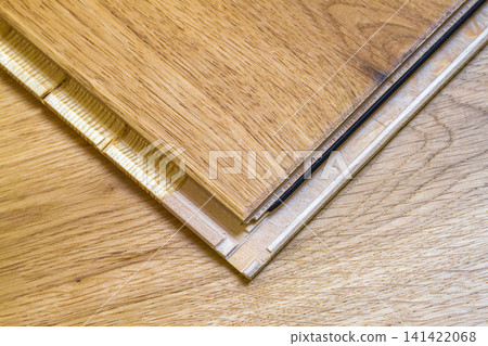 Brown wooden parquet floor planks installation , close up. Carpentry concept. Brown wooden parquet floor planks installation , close up. Carpentry concept. 141422068