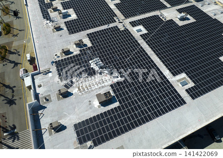 Broken down photovoltaic solar panels destroyed by hurricane Ian winds mounted on industrial building roof for producing green ecological electricity. Consequences of natural disaster Broken down photovoltaic solar panels destroyed by hurricane Ian winds mounted on industrial building roof for producing green ecological electricity. Consequences of natural disaster 141422069