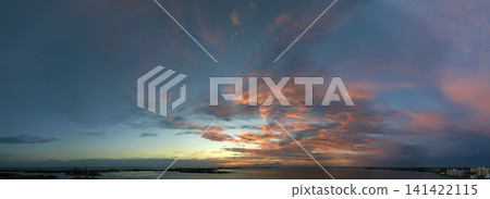 Beautiful sunset sky scenery. Bright colorful orange and yellow clouds on horizon Beautiful sunset sky scenery. Bright colorful orange and yellow clouds on horizon 141422115