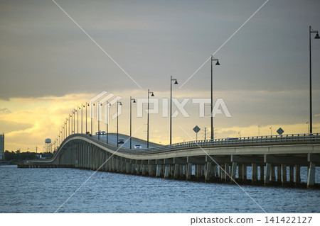 Barron Collier Bridge and Gilchrist Bridge in Florida with moving traffic. Transportation infrastructure in Charlotte County connecting Punta Gorda and Port Charlotte over Peace River Barron Collier Bridge and Gilchrist Bridge in Florida with moving traffic. Transportation infrastructure in Charlotte County connecting Punta Gorda and Port Charlotte over Peace River 141422127