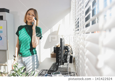 Business asian woman using mobile phone during checking an email or social media on internet. accounting financial concept. 141422924