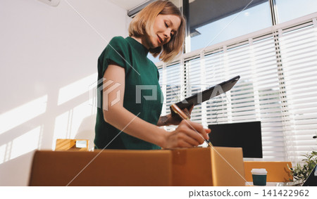 Logistics, small business woman with checklist for stock, clothes order or retail inventory management. Shipping, writing or person at ecommerce startup store for sme delivery with fashion designer Logistics, small business woman with checklist for stock, clothes order or retail inventory management. Shipping, writing or person at ecommerce startup store for sme delivery with fashion designer 141422962