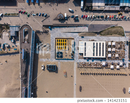 Beautiful top down high altitude aerial panoramic perspective of beach resort trampoline park pier ramp and boulevard promenade with vintage cars under bright sunlight Beautiful top down high altitude aerial panoramic perspective of beach resort trampoline park pier ramp and boulevard promenade with vintage cars under bright sunlight 141423151