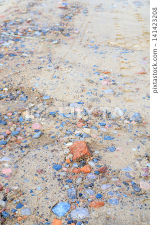 Rough gravel and sand ground texture. Natural background of  soil path with small pink granite pebbles, crushed stones 141423208