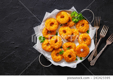 Golden Breaded Cheddar Rings on a serving tray Golden Breaded Cheddar Rings on a serving tray 141423395