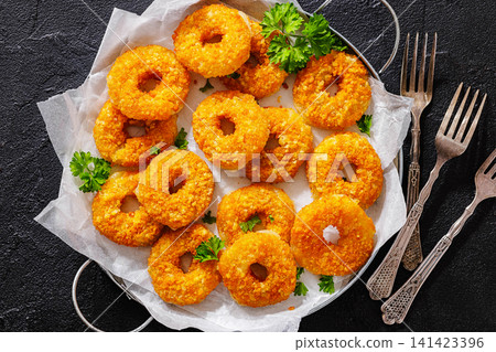 Golden Breaded Cheese Wheels On Paper on a tray Golden Breaded Cheese Wheels On Paper on a tray 141423396
