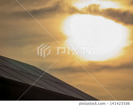 Solar panels illuminated by the setting sun and the shining sun | Landscape image representing renewable energy Solar panels illuminated by the setting sun and the shining sun | Landscape image representing renewable energy 141423586