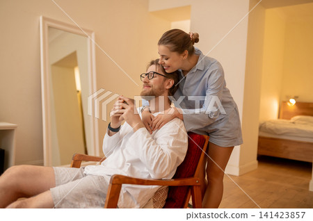 Young couple working on the project together at home and looking interested Young couple working on the project together at home and looking interested 141423857
