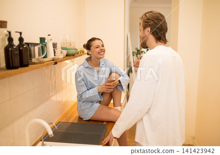 Cute young couple in the kitchen feeling excited and happy Cute young couple in the kitchen feeling excited and happy 141423942