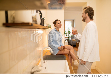 Cute young couple in the kitchen feeling excited and happy Cute young couple in the kitchen feeling excited and happy 141423944