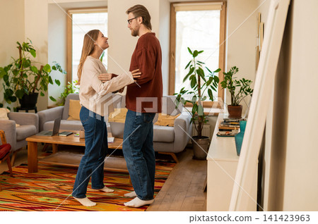 Young couple dancing in an old-fashioned room and feeling contented and happy Young couple dancing in an old-fashioned room and feeling contented and happy 141423963