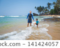 Caucasian father and son playing on tropical beach in Sri Lanka, joyful moment 141424057