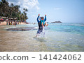 Caucasian Father Playfully Lifts His Son at Tropical Beach in Sri Lanka 141424062