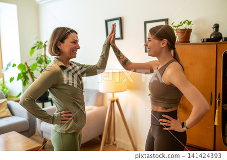 Happy fit women giving high five to each other Happy fit women giving high five to each other 141424393