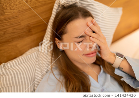Young woman feeling sleepy and unrested in the morning Young woman feeling sleepy and unrested in the morning 141424420
