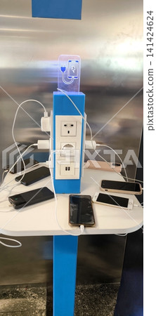 Mobile phone charging station in a public place Mobile phone charging station in a public place 141424624