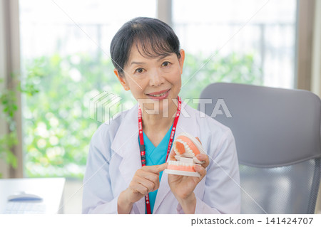 Senior female doctor conducting online consultations Senior female doctor conducting online consultations 141424707