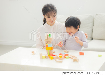 Parents playing with building blocks Parents playing with building blocks 141424943