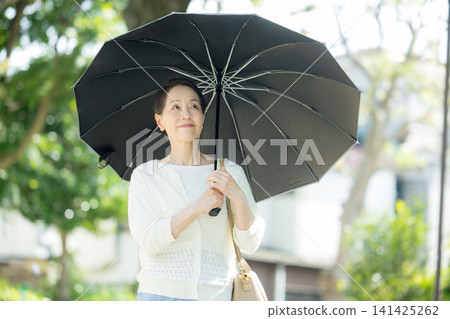 Senior woman sunblind Senior woman sunblind 141425262