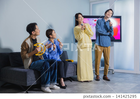 A man and a woman singing karaoke A man and a woman singing karaoke 141425295