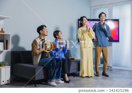 A man and a woman singing karaoke A man and a woman singing karaoke 141425296