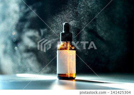 Amber serum bottle with dropper amidst a fine mist Amber serum bottle with dropper amidst a fine mist 141425304