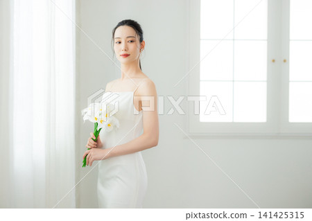young woman in a white dress young woman in a white dress 141425315