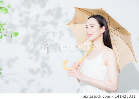 A woman holding a parasol A woman holding a parasol 141425331