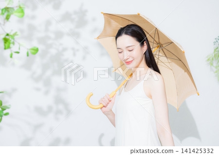 A woman holding a parasol A woman holding a parasol 141425332