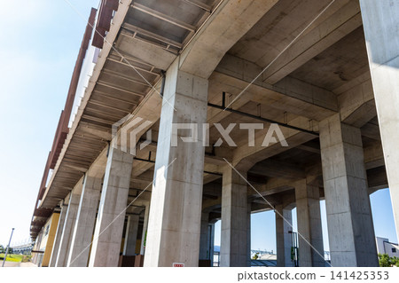 A dynamic landscape of concrete viaducts and bridge piers against a blue sky. A dynamic landscape of concrete viaducts and bridge piers against a blue sky. 141425353