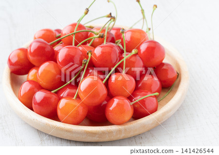 Cherries (Sato Nishiki variety) served on a wooden plate. Cherries (Sato Nishiki variety) served on a wooden plate. 141426544
