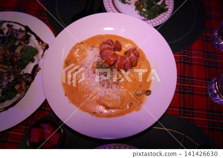 Gourmet Dish with Shrimp and Sausage in Creamy Sauce 141426630