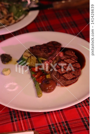 Grilled Steak Plate with Vegetables and Sauce 141426639