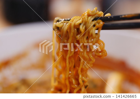Chopstick-Held Spicy Ramen Noodles Close-Up Chopstick-Held Spicy Ramen Noodles Close-Up 141426665