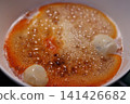 Caramelizing Sugar with Eggs in Pan 141426682