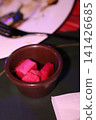 Pink Fruit in Ceramic Bowl on Table 141426685