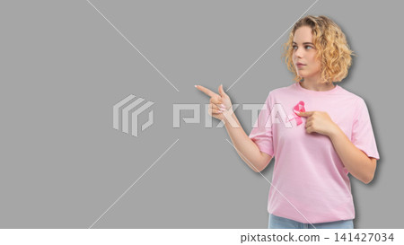 Person gestures with pink cancer awareness ribbon Person gestures with pink cancer awareness ribbon 141427034