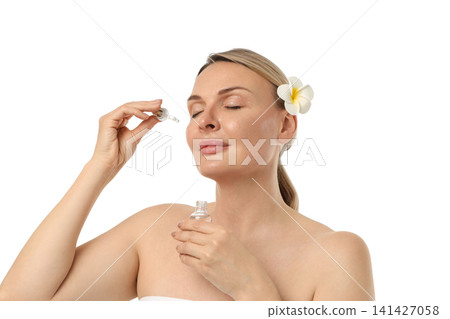 Woman applies skincare serum gently, isolated on white, PNG Woman applies skincare serum gently, isolated on white, PNG 141427058