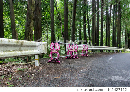 Barricades made of steel pipes installed along the side of a mountain path Barricades made of steel pipes installed along the side of a mountain path 141427112