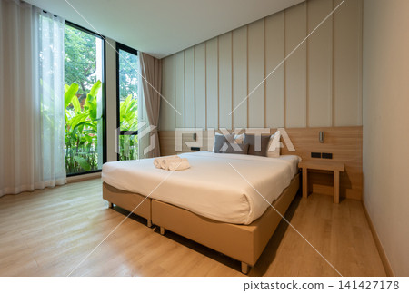 Scenery view in comfortable bed in hotel bedroom. Conceptual shot of a place for someone to stay, live, or work temporary. Scenery view in comfortable bed in hotel bedroom. Conceptual shot of a place for someone to stay, live, or work temporary. 141427178