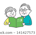 A senior couple looking at a pamphlet about elderly care. 141427573